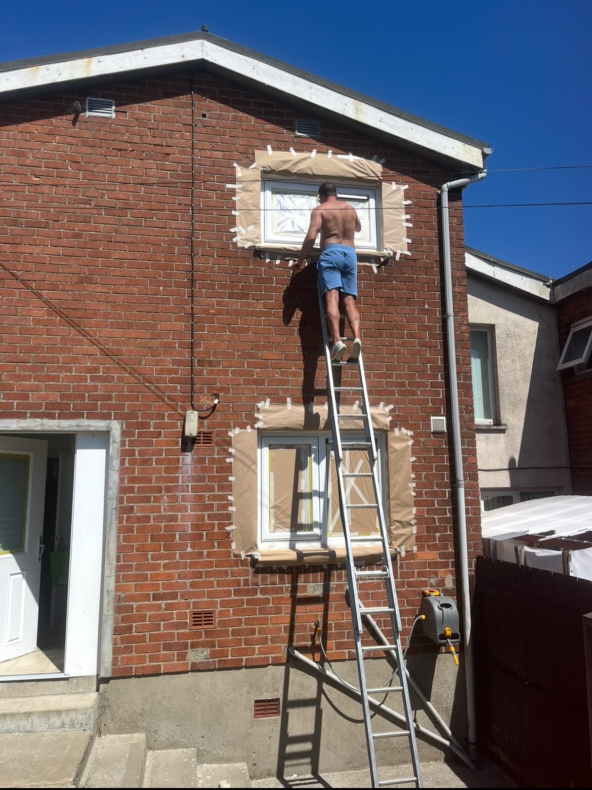 Sherpa Coatings spraying PVC windows of a house